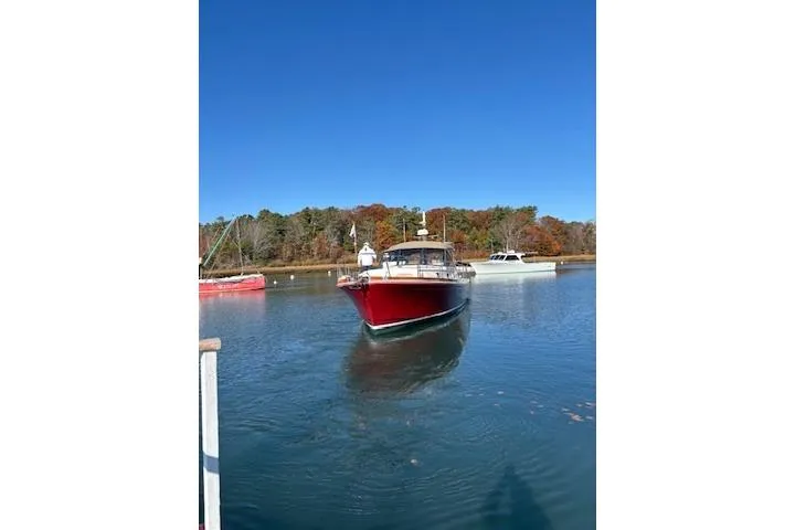 Slide: The Image of Red 1998 Grand Banks 38 Eastbay EX yacht on calm water, clear blue sky. - 11