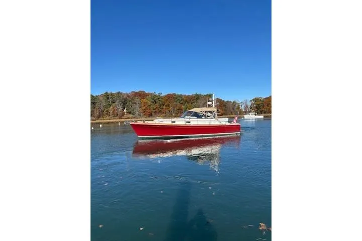 Slide: The Image of 1998 Grand Banks 38 Eastbay EX boat on calm water, clear sky background. - 14