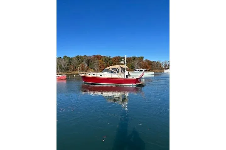 Slide: The Image of 1998 Grand Banks 38 Eastbay EX boat on calm water, clear blue sky. - 17