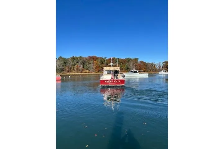 Slide: The Image of 1998 Grand Banks 38 Eastbay EX boat on calm water, clear blue sky. - 21