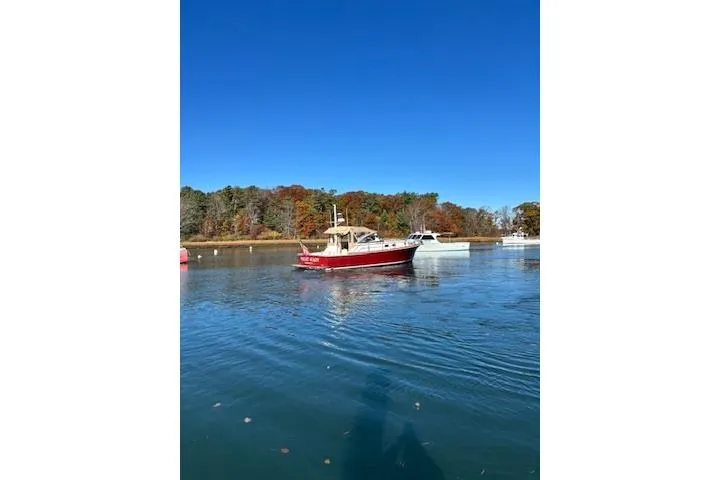 Slide: The Image of 1998 Grand Banks 38 Eastbay EX cruising on a calm lake with autumn trees in the background. - 22