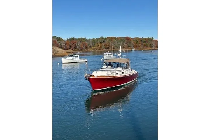 Slide: The Image of 1998 Grand Banks 38 Eastbay EX cruising on a serene lake with autumn foliage. - 25