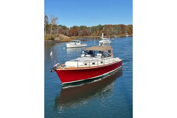 Slide: The Image of 1998 Grand Banks 38 Eastbay EX cruising on a serene river with other boats. - 28
