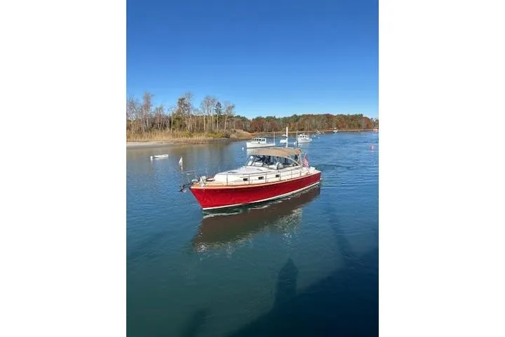 Slide: The Image of 1998 Grand Banks 38 Eastbay EX boat cruising on a calm, scenic waterway. - 29