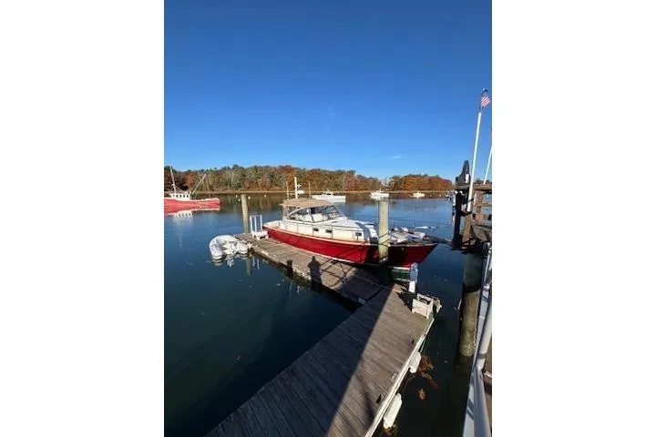Slide: The Image of 1998 Grand Banks 38 Eastbay EX docked on a sunny day, surrounded by calm waters. - 3