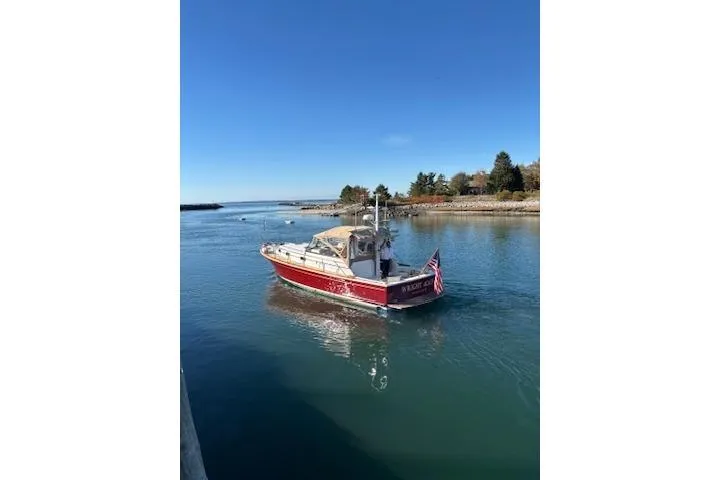 Slide: The Image of 1998 Grand Banks 38 Eastbay EX cruising in a serene coastal waterway. - 38
