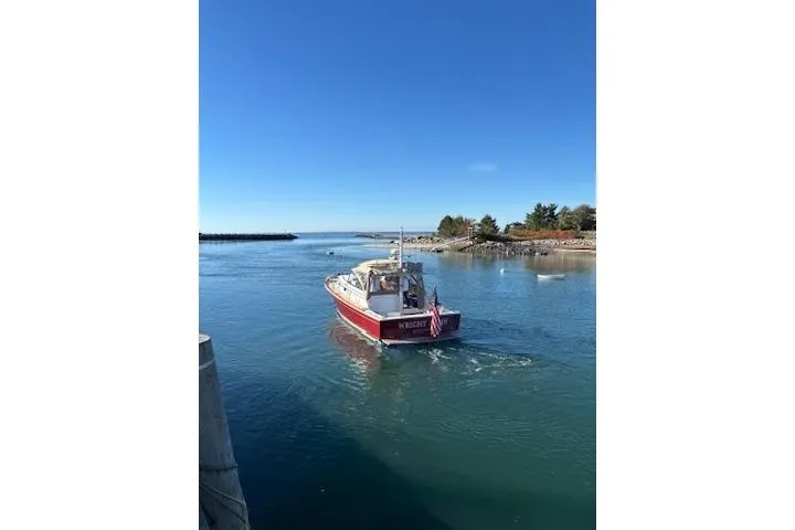 Slide: The Image of 1998 Grand Banks 38 Eastbay EX boat cruising in a calm, scenic waterway. - 40