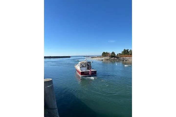 Slide: The Image of 1998 Grand Banks 38 Eastbay EX cruising on a clear blue waterway under a bright sky. - 41