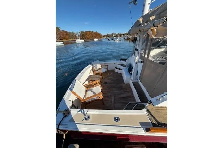 Slide: The Image of 1998 Grand Banks 38 Eastbay EX yacht with wooden deck chairs on a sunny day. - 7