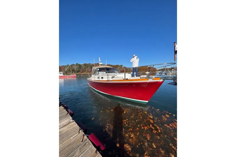 Slide: The Image of 1998 Grand Banks 38 Eastbay EX boat docked, vibrant red hull, clear blue sky. - 9