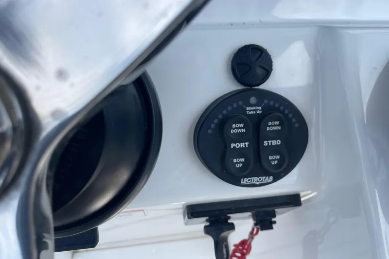 Slide: The Image of Control panel of a 2018 Everglades 230 Center Console boat with Lectrotab trim tab switches. - 11
