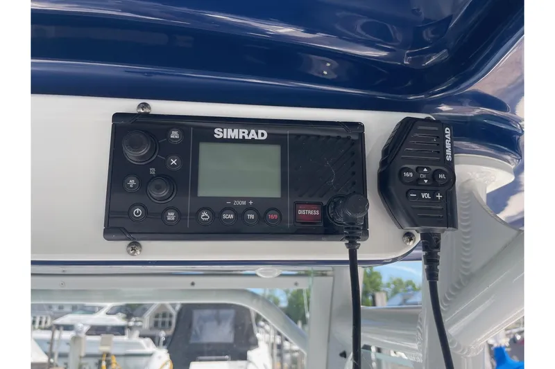 Slide: The Image of Simrad marine radio on 2018 Everglades 230 Center Console boat dashboard. - 13
