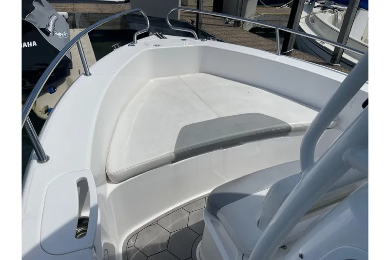 Slide: The Image of 2018 Everglades 230 Center Console boat interior with cushioned seating and railing. - 16