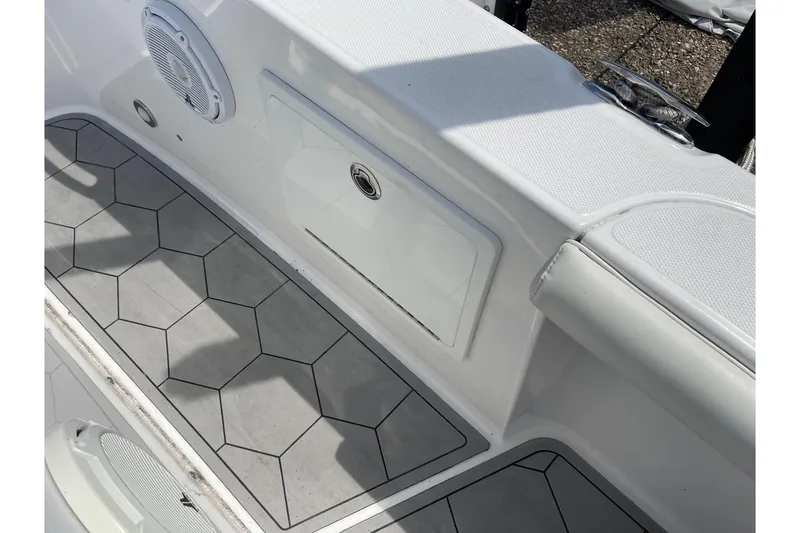 Slide: The Image of 2018 Everglades 230 Center Console boat interior with hexagonal flooring and speaker. - 18