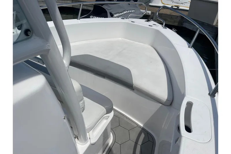 Slide: The Image of 2018 Everglades 230 Center Console boat interior with seating and railing. - 19