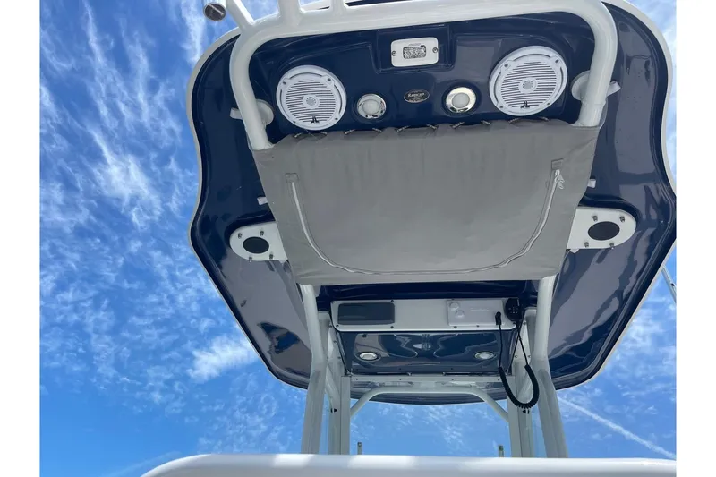 Slide: The Image of 2018 Everglades 230 Center Console boat roof with speakers against a blue sky. - 20