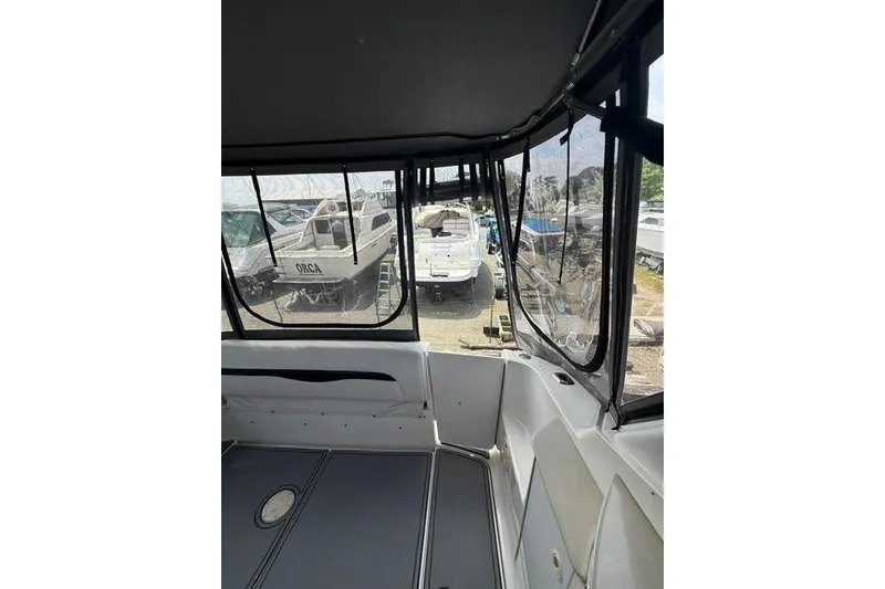 Slide: The Image of Interior view of a 2002 Chaparral 350 Signature boat with marina background. - 10