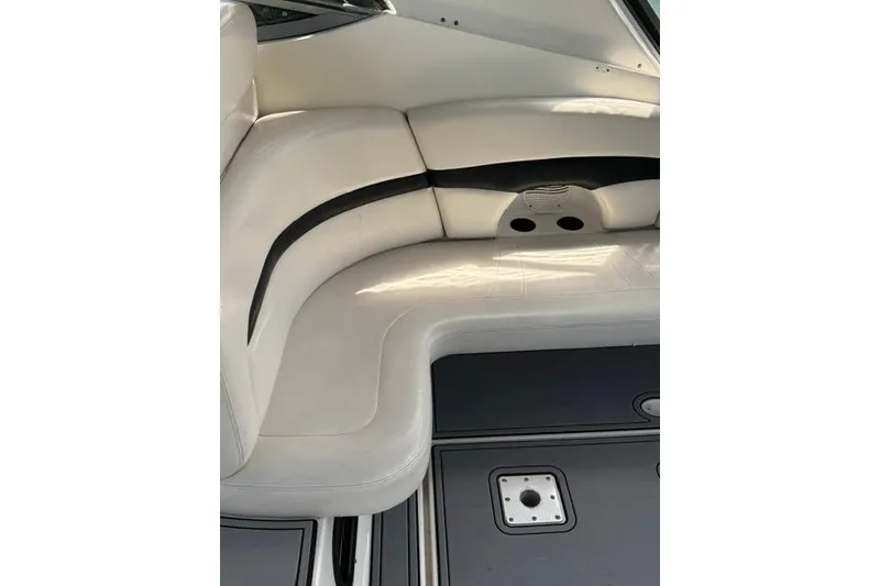 Slide: The Image of Interior seating of 2002 Chaparral 350 Signature boat, featuring white upholstery and sleek design. - 12