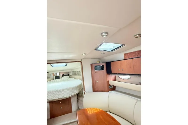 Slide: The Image of Interior of 2002 Chaparral 350 Signature yacht with cozy seating and wooden cabinetry. - 18