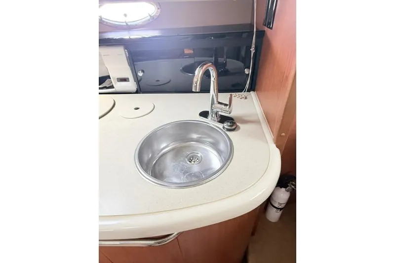 Slide: The Image of 2002 Chaparral 350 Signature yacht kitchen sink with modern faucet and countertop. - 20
