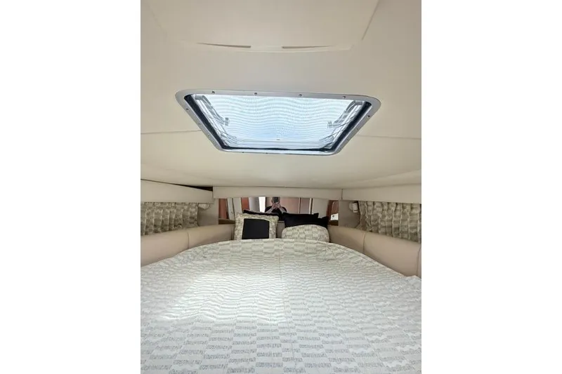 Slide: The Image of Interior cabin of 2002 Chaparral 350 Signature boat with skylight and cozy bedding. - 22