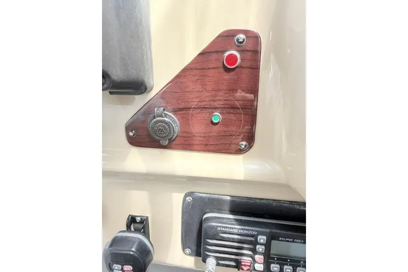 Slide: The Image of Control panel of a 2002 Chaparral 350 Signature boat with 12V socket and indicators. - 27