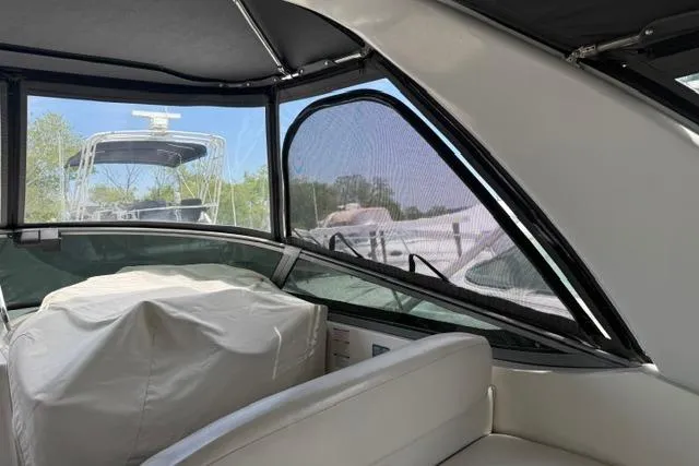 Slide: The Image of 2002 Chaparral 350 Signature boat interior with covered seating and clear windows. - 7