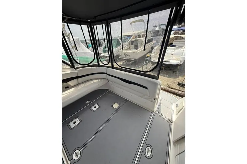 Slide: The Image of Interior view of 2002 Chaparral 350 Signature boat with docked vessels outside. - 9