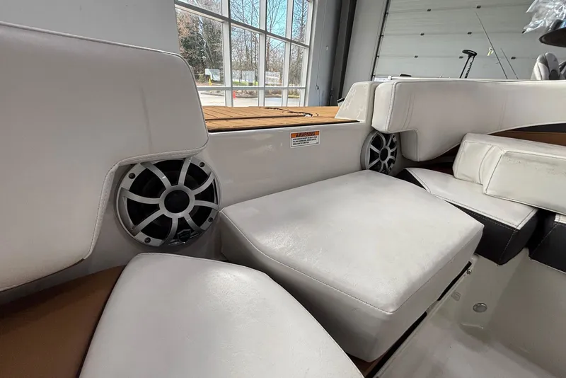 Slide: The Image of Interior of 2025 Starcraft SVX 191 OB with speakers and white seating. - 11