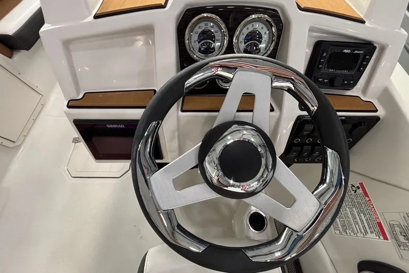 Slide: The Image of 2025 Starcraft SVX 191 OB helm with modern instruments and steering wheel. - 9