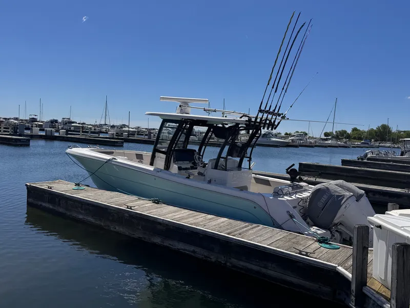 Slide: The Image of A Robalo R302 Center Console boat docked at a marina. - 15