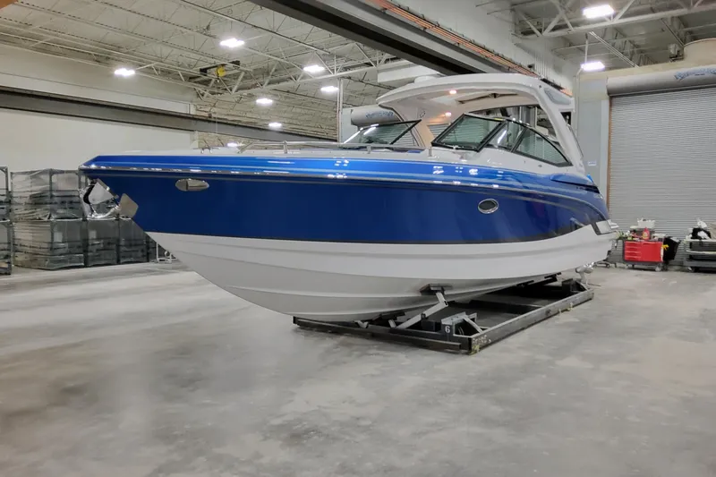 The Image of 2027 Formula 330 Crossover Bowrider OB in a showroom, showcasing sleek design. - 1