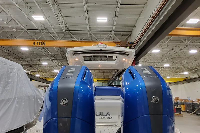 Slide: The Image of 2027 Formula 330 Crossover Bowrider OB with dual outboard engines in a warehouse setting. - 11