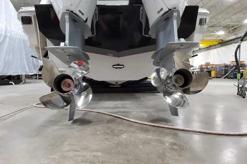 Slide: The Image of Dual outboard motors on a 2027 Formula 330 Crossover Bowrider OB in a workshop. - 13