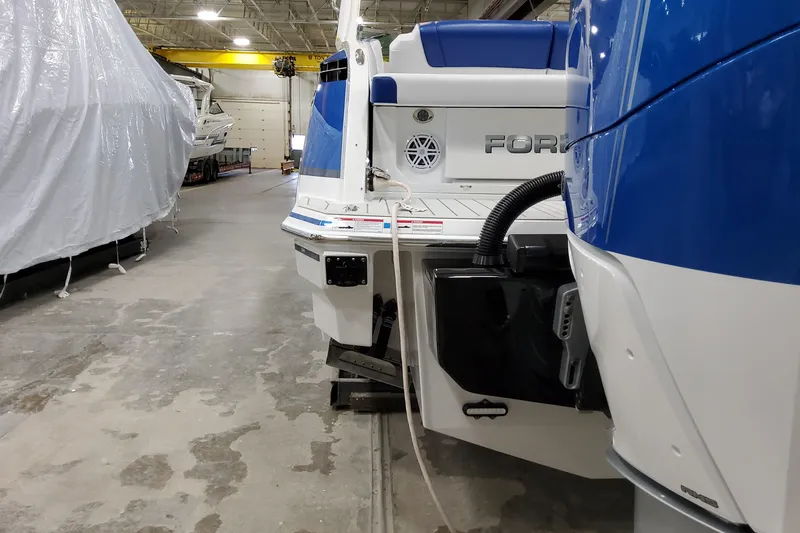Slide: The Image of 2027 Formula 330 Crossover Bowrider OB in a boat storage facility. - 14