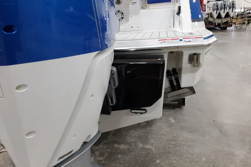 Slide: The Image of 2027 Formula 330 Crossover Bowrider OB, rear view with outboard motor in a showroom. - 15