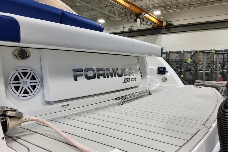 Slide: The Image of 2027 Formula 330 Crossover Bowrider OB in a showroom, showcasing sleek design and branding. - 16