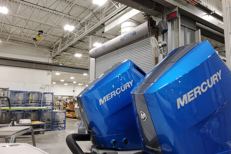Slide: The Image of Blue Mercury Verado outboard engines in a factory setting, 2027 Formula 330 Crossover Bowrider OB. - 18