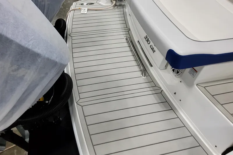 Slide: The Image of 2027 Formula 330 Crossover Bowrider OB boat deck with sleek design and blue accents. - 19