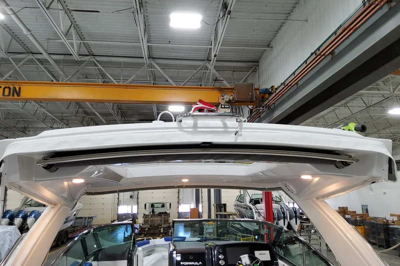 Slide: The Image of 2027 Formula 330 Crossover Bowrider OB in a factory setting, showcasing its sleek design. - 22