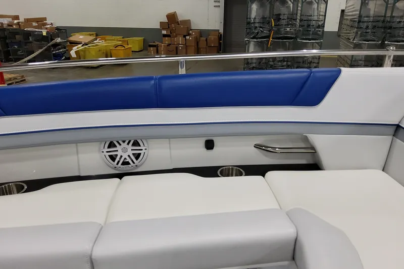 Slide: The Image of 2027 Formula 330 Crossover Bowrider OB interior with blue and white seating, speaker, and cup holders. - 30