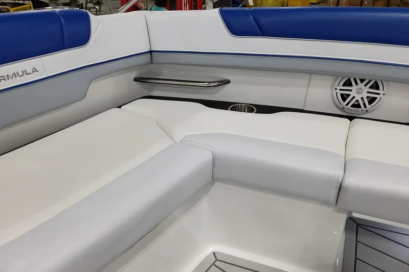 Slide: The Image of 2027 Formula 330 Crossover Bowrider OB interior with white and blue seating, speaker, and cup holder. - 31