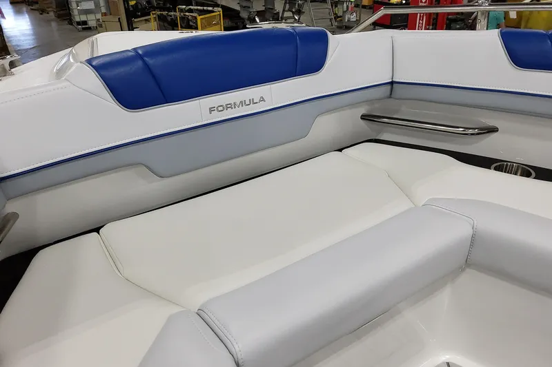 Slide: The Image of 2027 Formula 330 Crossover Bowrider OB interior with blue and white seating in a showroom. - 32