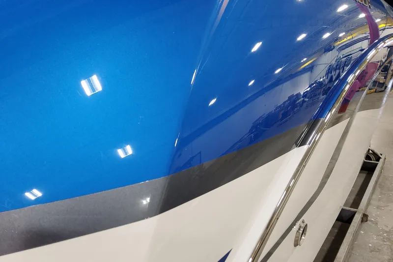 Slide: The Image of Close-up of a 2027 Formula 330 Crossover Bowrider OB's sleek blue hull. - 4