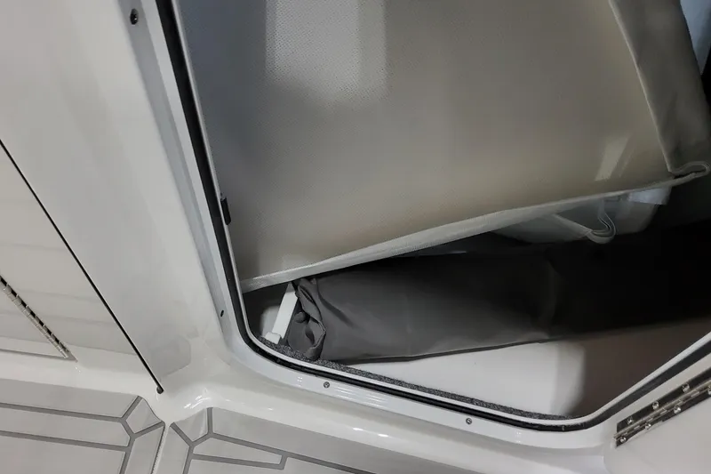 Slide: The Image of Storage compartment in 2027 Formula 330 Crossover Bowrider OB boat, featuring sleek interior design. - 40