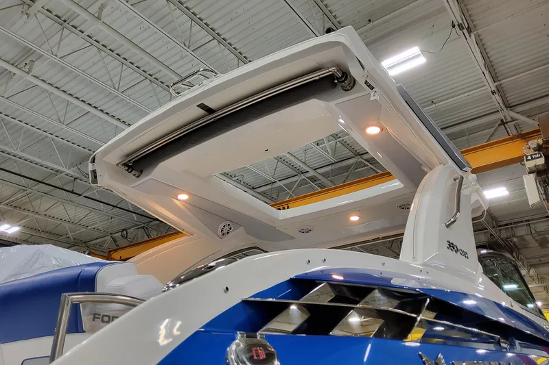 Slide: The Image of 2027 Formula 330 Crossover Bowrider OB in a showroom, showcasing sleek design and lighting. - 5