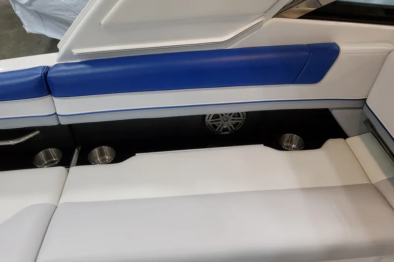 Slide: The Image of 2027 Formula 330 Crossover Bowrider OB interior with blue and white seating, cup holders, and speaker. - 51