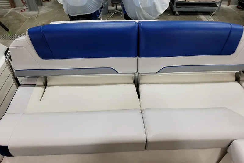 Slide: The Image of 2027 Formula 330 Crossover Bowrider OB boat seating, featuring blue and white upholstery. - 54