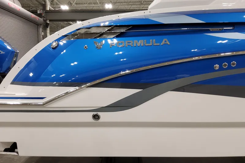 Slide: The Image of 2027 Formula 330 Crossover Bowrider OB, sleek blue and white design, side view. - 6