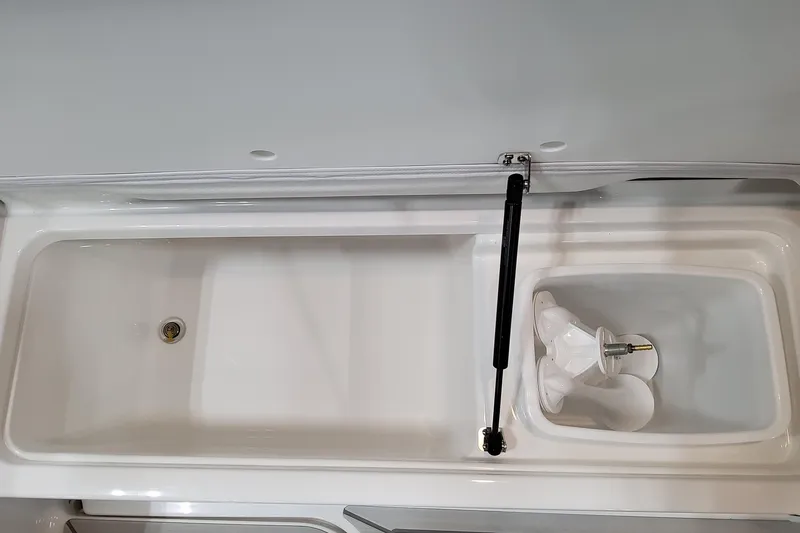 Slide: The Image of 2027 Formula 330 Crossover Bowrider OB storage compartment with hydraulic lift and drain. - 67